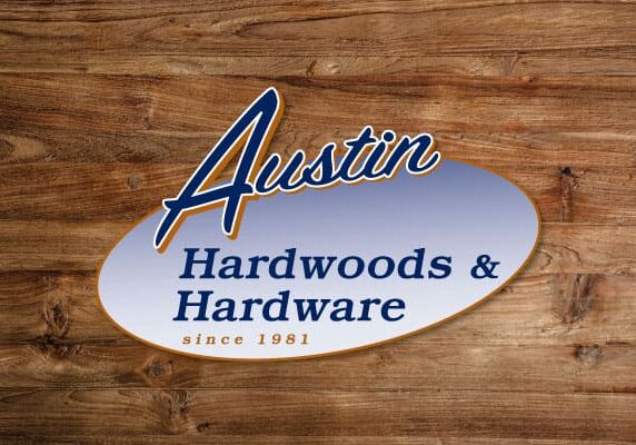 Original Austin Hardwoods and Hardware logo centered on wood texture