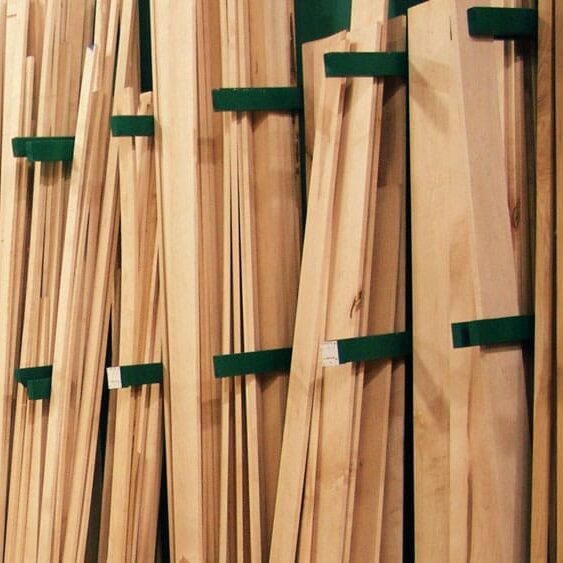 Lumber leaning against wall in various sizes and materials